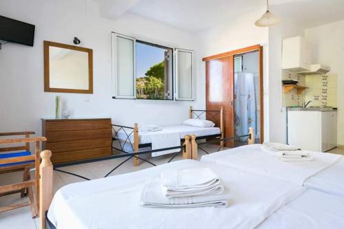 a room with two beds and a window at Αngelika studios in Argostoli