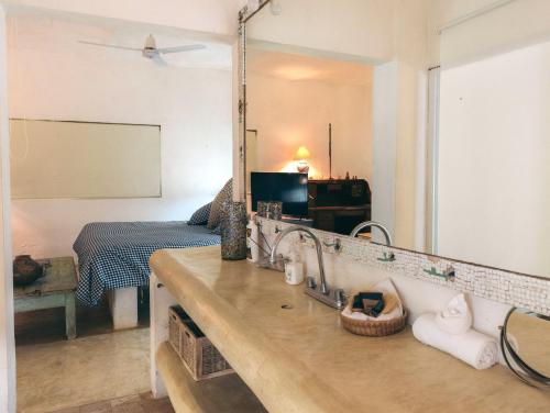 a bathroom with a sink and a mirror at Junto al Rio Bungalows & Suites in Sayulita