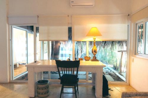 a kitchen with a table with two chairs and a lamp at Junto al Rio Bungalows & Suites in Sayulita