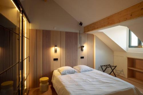 a bedroom with a large bed in a attic at Maison Prestige proche Disney in Bussy-Saint-Georges