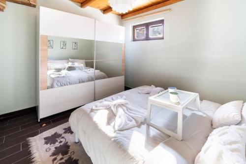 a bedroom with two beds and a mirror at Kaimaktsalan maisonette in Palaios Agios Athanasios