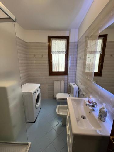 a bathroom with a sink and a toilet and a shower at Casa Vacanze Linda in Gera Lario