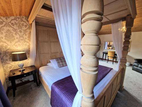 a bedroom with a bed and a pillar at Lomond 6 with Private Hot Tub - Fife - Loch Leven - Lomond Hills in Kelty
