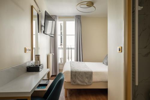 a hotel room with a bed and a desk and a window at Hôtel des Deux Avenues in Paris