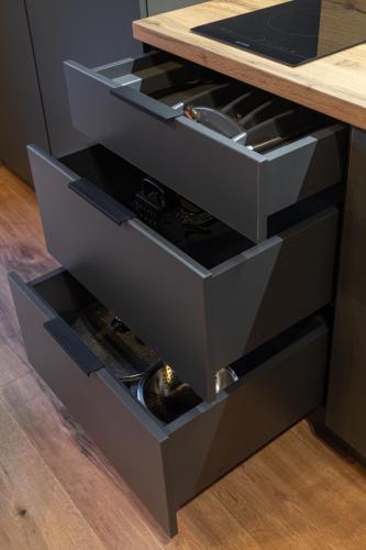 a kitchen island with three drawers with wine bottles at Phoenix Medical Resort in Skhidnitsa