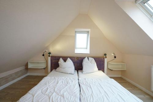 a bed with two pillows on it in a attic at Ferienwohnung Seewind am Schweriner See in Flessenow