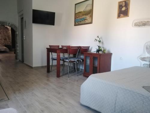 a bedroom with a desk and a table and chairs at Pandera areopoli in Areopolis