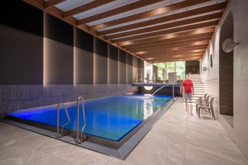 a swimming pool in the middle of a house at Hotel Astor in Jastrzębia Góra