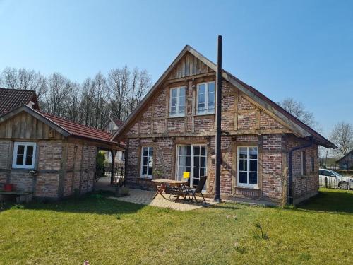 a stone house with a picnic table in the yard at Ferienhaus im Seedorf im Münsterland Warendorf in Warendorf