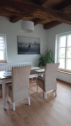a dining room with a table and two chairs at Ferienhaus im Seedorf im Münsterland Warendorf in Warendorf