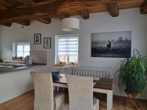 a kitchen with a table and chairs in a room at Ferienhaus im Seedorf im Münsterland Warendorf in Warendorf
