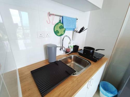 a small kitchen with a sink and a counter at Plaza @ Kelana Jaya 2 Bedroom House NEW 2024! in Petaling Jaya