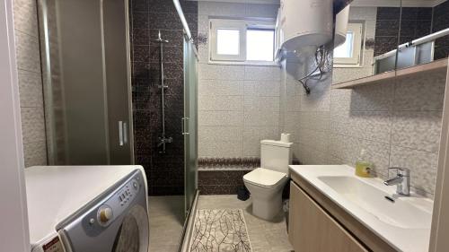 a bathroom with a toilet and a sink and a shower at MVP59 in Kallithéa