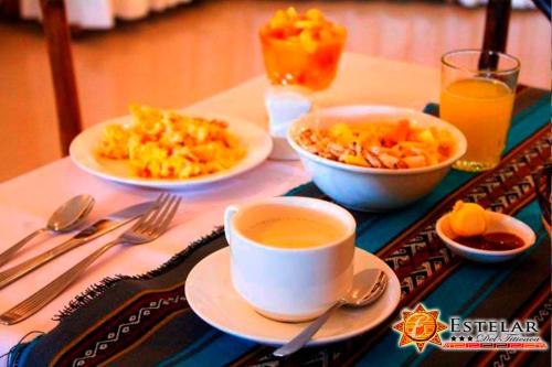 una mesa con platos de comida y una taza de café en HOTEL ESTELAR del TITICACA, en Copacabana