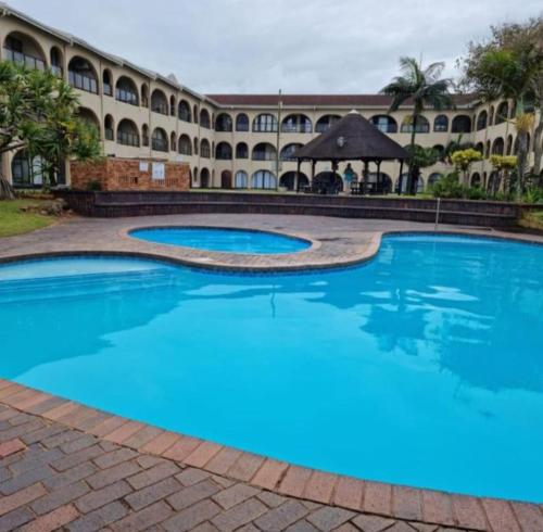 a large swimming pool in front of a building at 78 Cabanas Del Mar in Kingsburgh