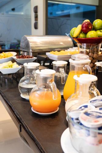 a buffet of food with orange juice and fruit at Blank Hotel Recoleta in Buenos Aires