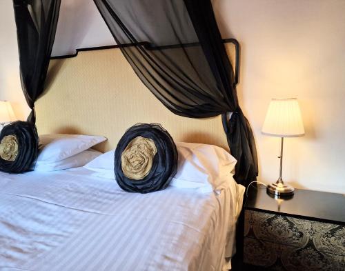 a bedroom with a bed with black mosquito nets on it at Torridon 12 with Private Hot Tub - Fife - Loch Leven - Lomond Hills in Kelty