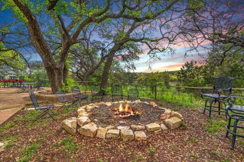 a fire pit in a park with chairs and trees at Lighthouse Hill Ranch - Brown House in Johnson City
