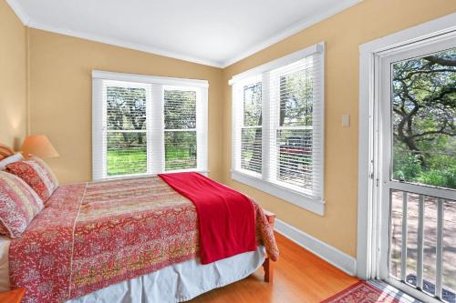 a bedroom with a bed and two windows at Lighthouse Hill Ranch - Brown House in Johnson City