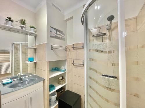 a bathroom with a shower and a sink at Le Petit Magellan by Welcome to Cannes in Cannes