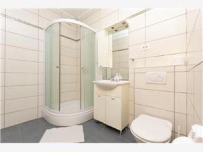 a bathroom with a toilet and a shower and a sink at Apartmani Livajić in Duće