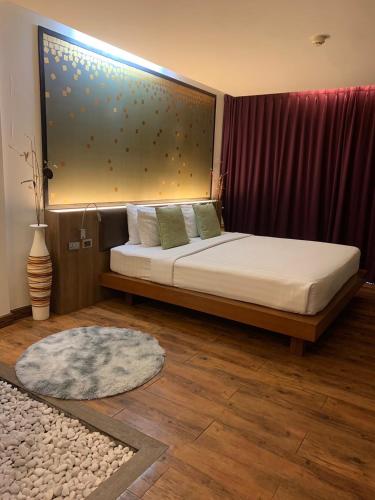 a bedroom with a bed with a large window at Luxury Suite Room by Atlas X in Kata Beach