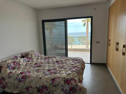 a bedroom with a bed and a large window at Marchica nador in Nador