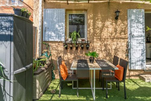 un patio avec une table et des chaises sur l'herbe dans l'établissement Rayonnante maison Mont Ventoux, à Villes-sur-Auzon