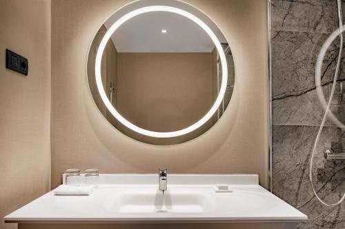 a bathroom with a sink and a mirror at AC Hotel by Marriott Clodio Roma in Rome