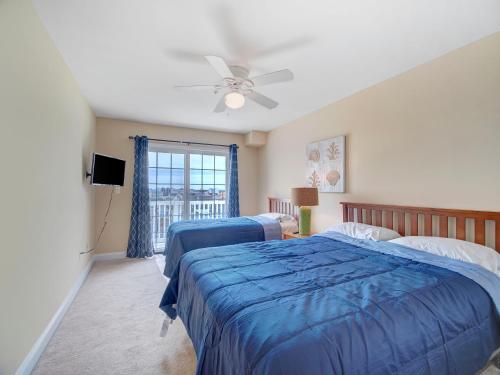 a bedroom with two beds and a ceiling fan at Summers at Sumner in Seaside Heights