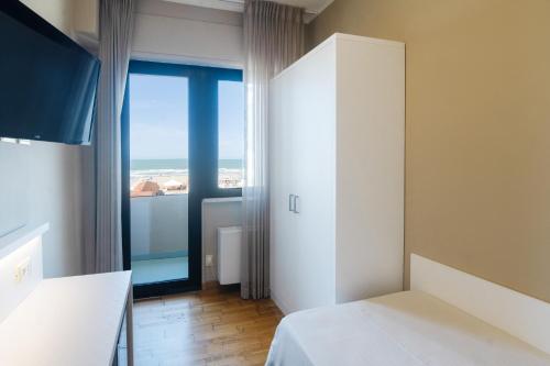 a bedroom with a view of the ocean at Hotel San Francisco in Viareggio