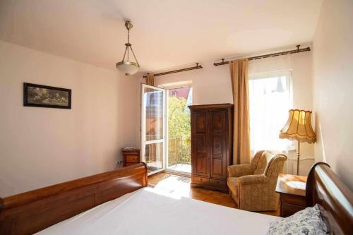 a bedroom with a bed and a chair and a window at apart wroclaw in Wrocław