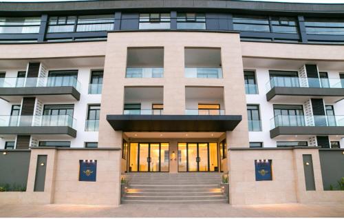 a large building with a front door in front at Embassy Gardens Royal Suites Apartments in Accra