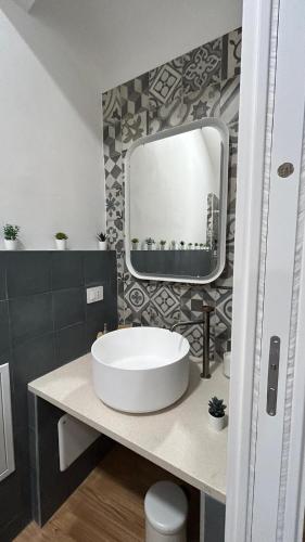 a bathroom with a white sink and a mirror at Casa dei Martiri in Altamura