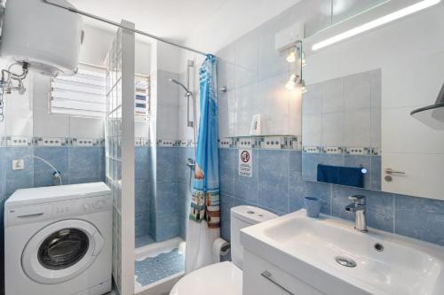 a bathroom with a washing machine and a sink at Apartamento La Concha in Candelaria