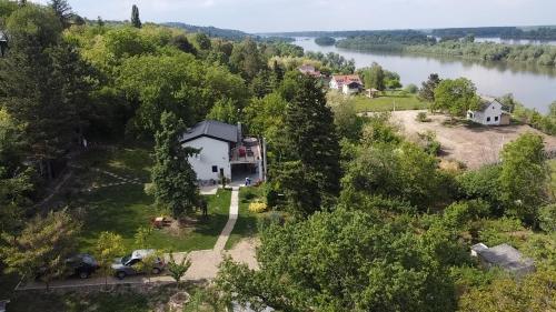 an aerial view of a house on a hill next to a river at Honey Spa house in Novi Slankamen