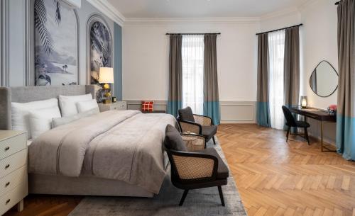 a bedroom with a large bed and a desk at River Dance Suites by Adrez in Prague