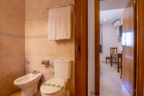 a bathroom with a toilet and a sink at Hotel Club Sunway Punta Prima in Es Pujols