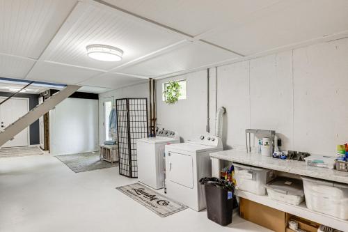 a kitchen with two washer and dryers in it at Dry Ridge Farmhouse with Hot Tub and Game Room! in Dry Ridge