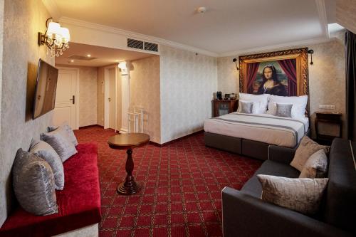 a hotel room with a bed and a couch at Mystery Hotel Budapest in Budapest