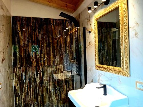 a bathroom with a shower with a sink and a mirror at angolo di paradiso in Formello