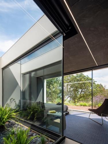 a glass extension of a house with a living room at Hotel Pepe Vieira in Raxo
