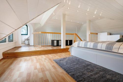 a bedroom with a bed in a room with an attic at Ferienwohnung Weingut Löwenthal in Eschbach