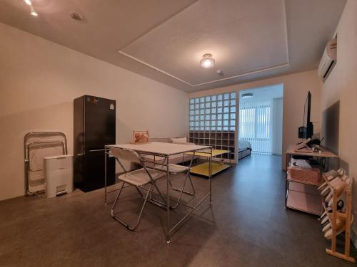 a living room with a table and a refrigerator at Yangjae Promenade,park,cafe street&Relaxation in Seoul