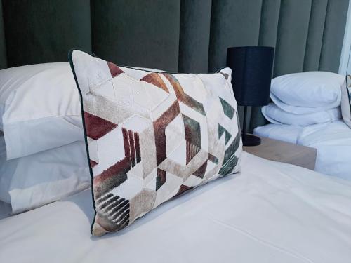 a pillow sitting on top of a bed at Executive Apartment at Ellipse Waterfall in Midrand