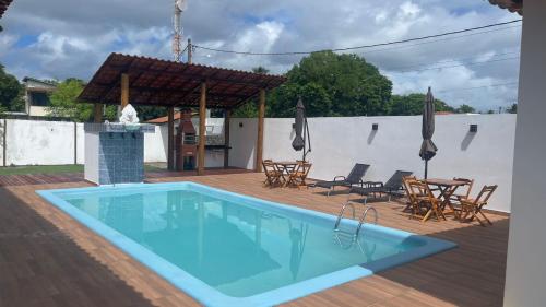 a swimming pool on a deck with a table and chairs at Pousada da Ilha ECO LAZER in Una