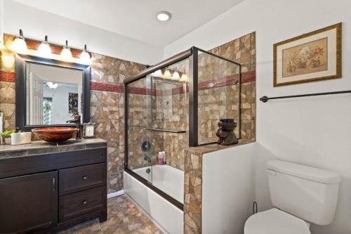 a bathroom with a shower and a toilet and a sink at Oak Scottsdale - BOHO Scottsdale Oasis Getaway-Pool-Hottub-ZenRoom in Scottsdale