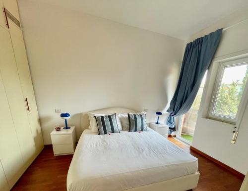 a bedroom with a white bed and a window at Edi's House in Rome