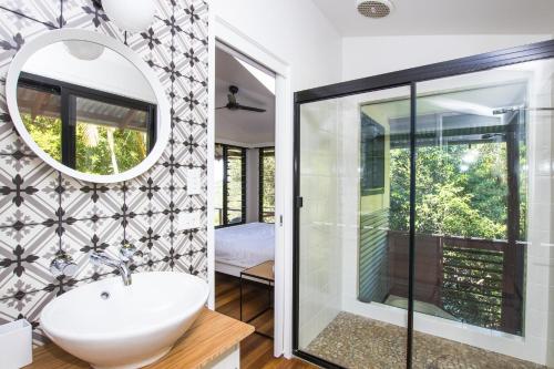 a bathroom with a sink and a mirror at Tallaringa Views in Alstonville