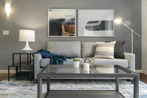 a living room with a couch and a coffee table at Landing at Axis Waterfront - 1 Bedroom in Downtown Benbrook in Fort Worth
